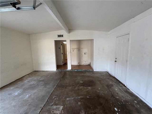 empty room with lofted ceiling with beams