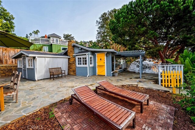 view of patio featuring an outbuilding and a pergola