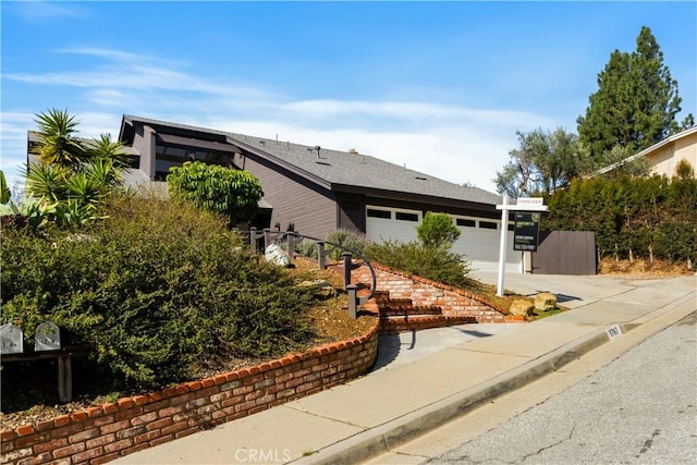 view of home's exterior featuring a garage and driveway