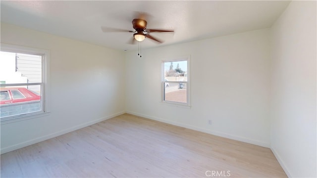 spare room with ceiling fan and light wood-type flooring