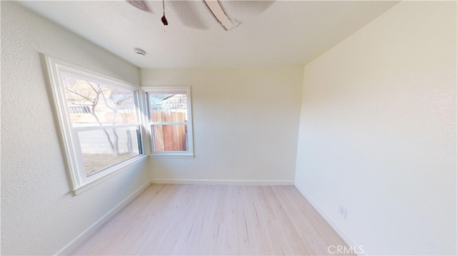 1425 N Howard Ave, Fresno, CA 93703 - unfurnished room with ceiling fan, light wood finished floors, and baseboards