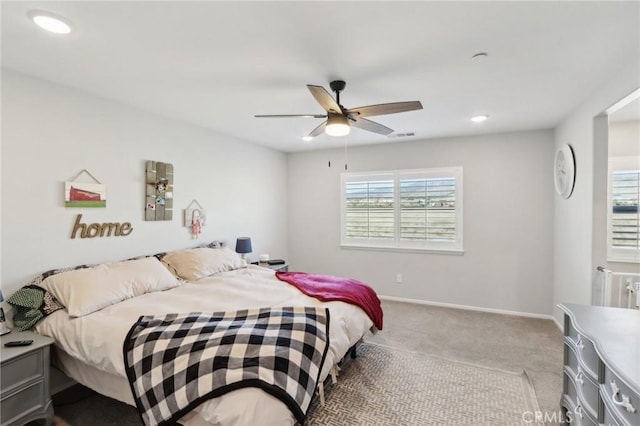 bedroom featuring light colored carpet and ceiling fan