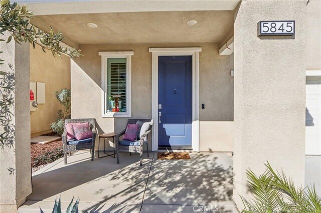 entrance to property featuring a patio area