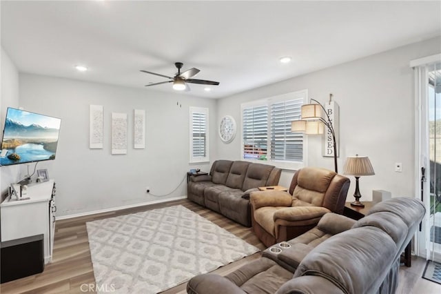 living room featuring hardwood / wood-style floors and ceiling fan