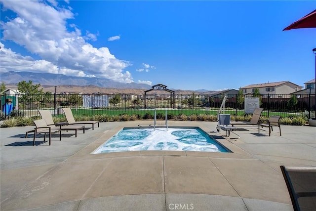 view of swimming pool with a mountain view and a patio area