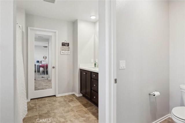 bathroom featuring vanity and toilet