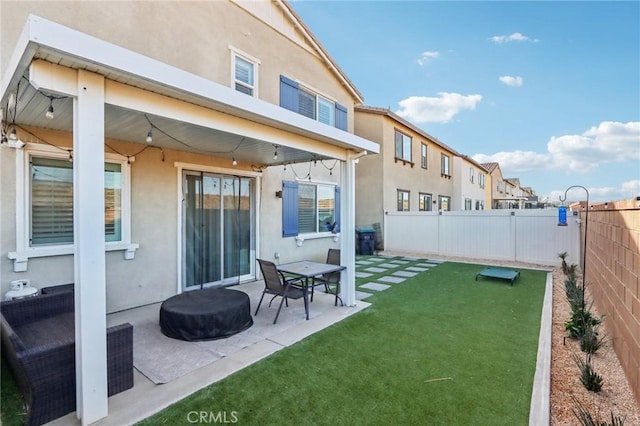 rear view of property with a yard and a patio