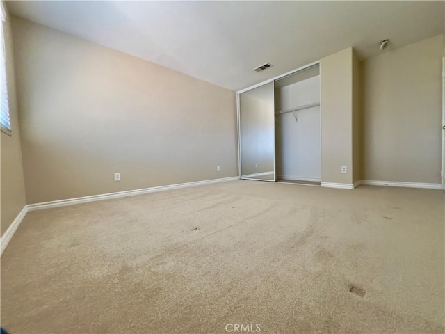 unfurnished bedroom with carpet flooring and a closet