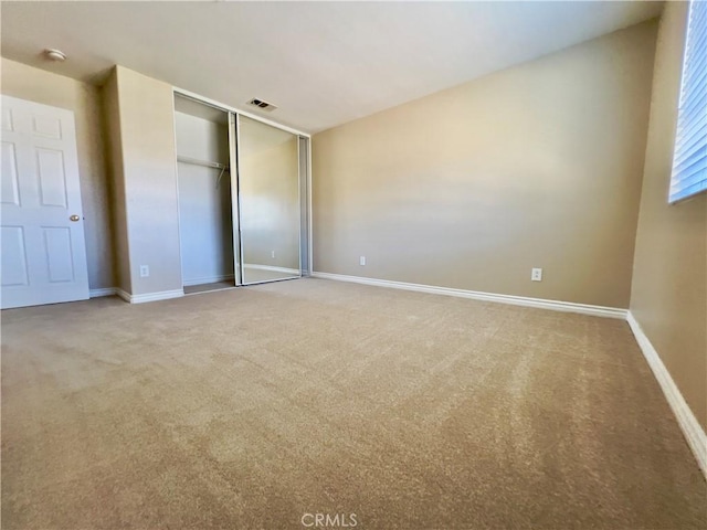 unfurnished bedroom with carpet and a closet