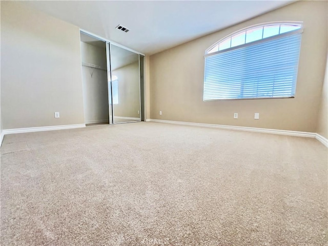 unfurnished bedroom featuring carpet and a closet