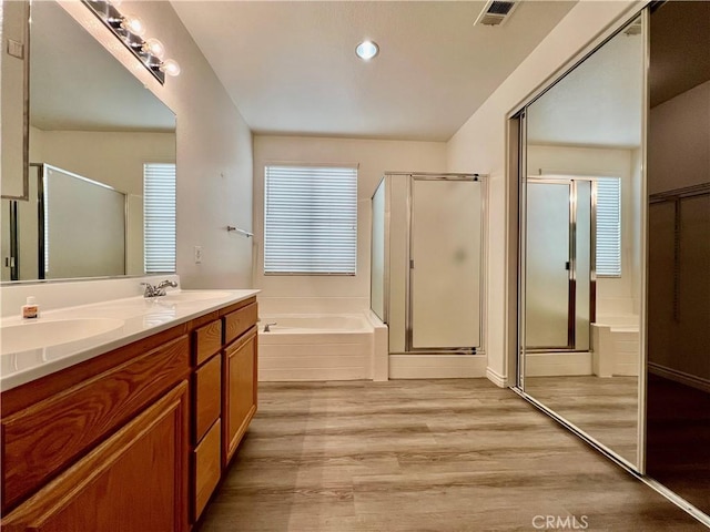 bathroom featuring vanity, shower with separate bathtub, wood-type flooring, and plenty of natural light