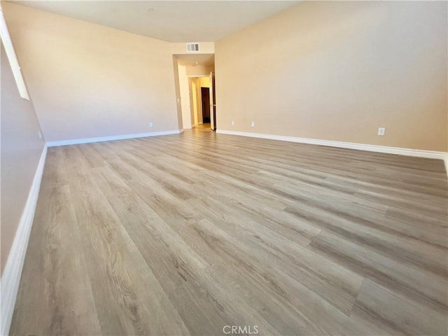 spare room with light hardwood / wood-style floors