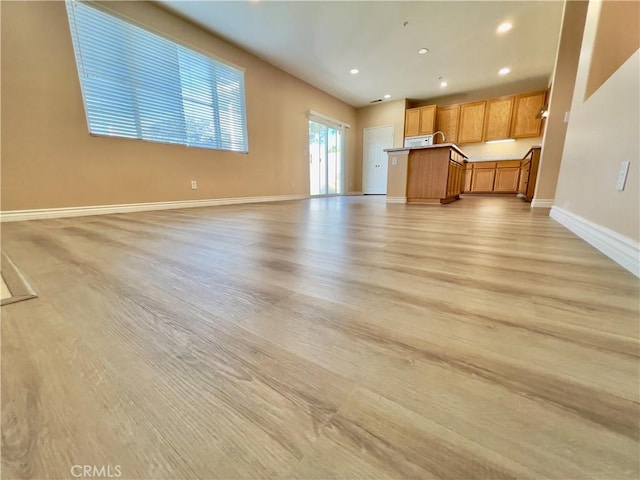 unfurnished living room with light hardwood / wood-style flooring