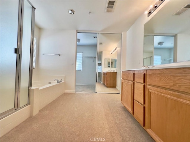 bathroom with vanity and independent shower and bath