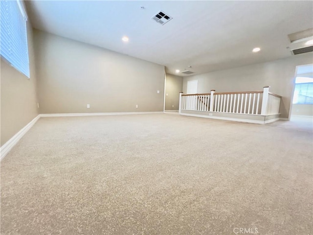 unfurnished room featuring light carpet