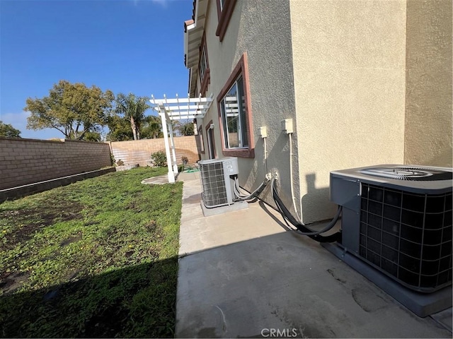 view of yard with a pergola, a patio area, and central air condition unit