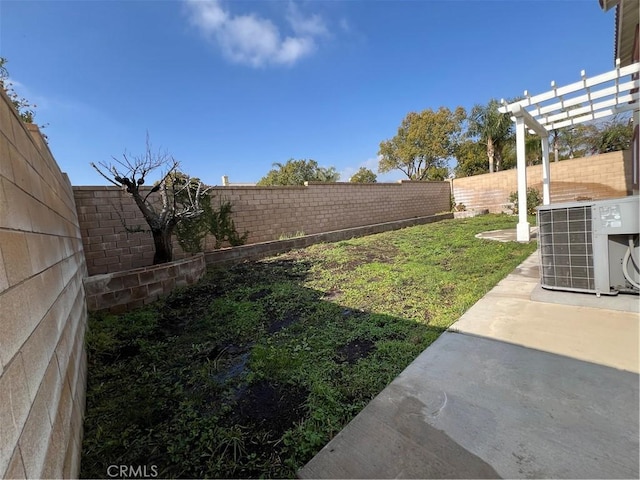 view of yard featuring cooling unit, a pergola, and a patio