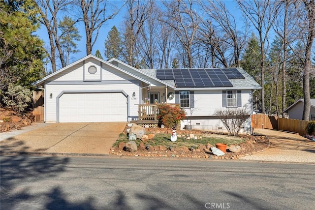 single story home with a garage and solar panels