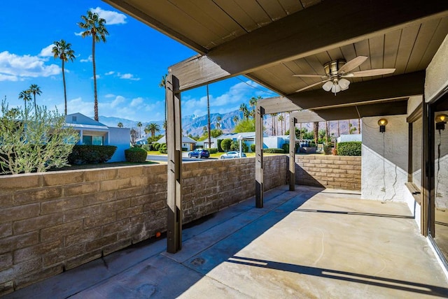 view of patio / terrace with a mountain view and ceiling fan