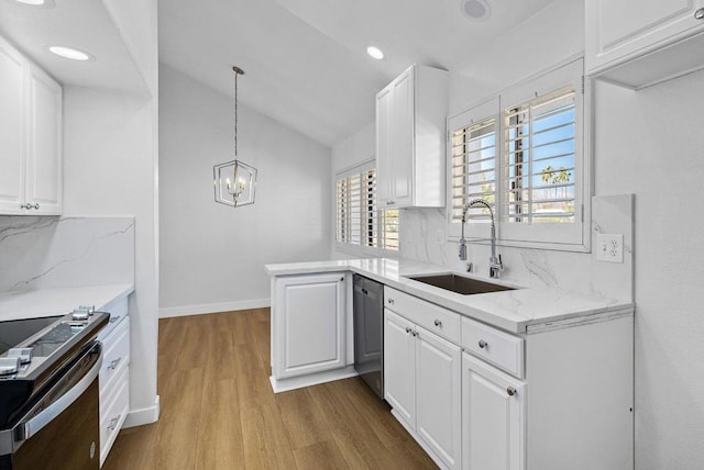 kitchen featuring appliances with stainless steel finishes, pendant lighting, sink, white cabinets, and kitchen peninsula