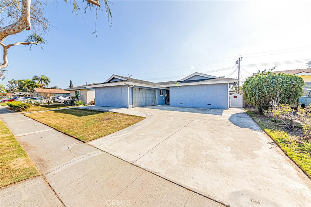 single story home with a garage and a front yard