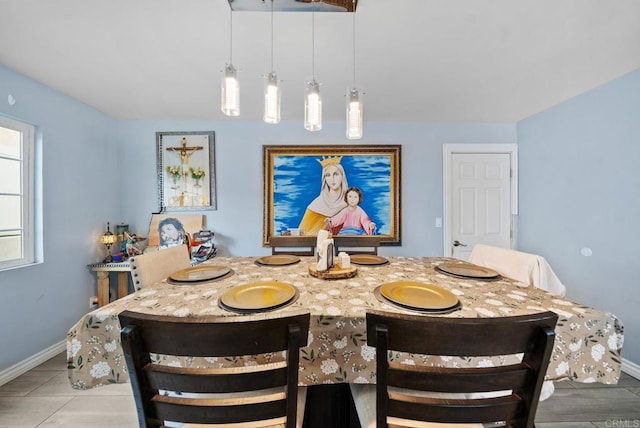 dining space featuring light tile patterned flooring