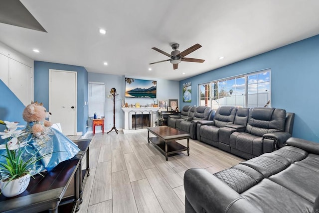 living room with ceiling fan and light wood-type flooring