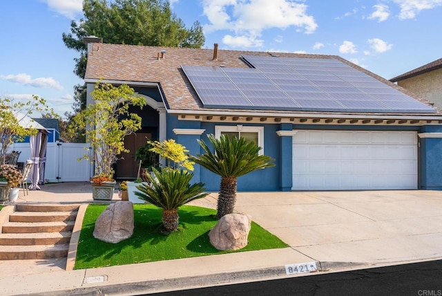 view of front of home featuring a garage and solar panels