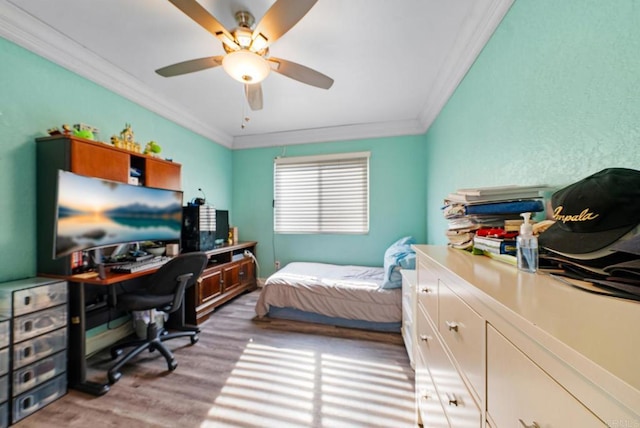 bedroom featuring crown molding, wood-type flooring, and ceiling fan