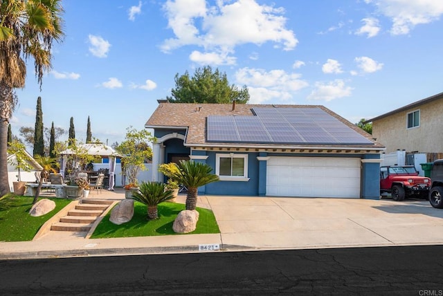 view of front of house with a garage and solar panels