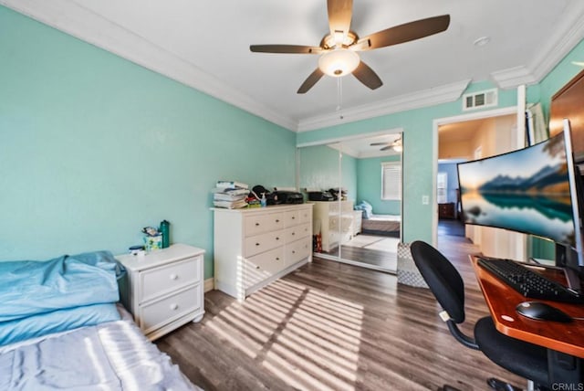 bedroom with ceiling fan, ornamental molding, and dark hardwood / wood-style flooring