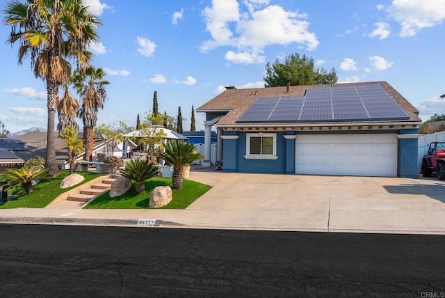 view of front facade featuring a garage and solar panels