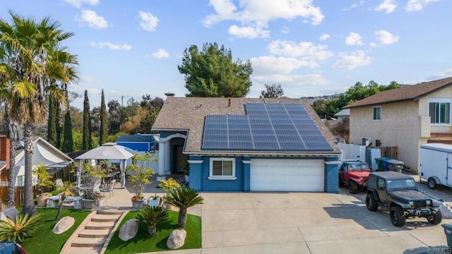 view of front of home featuring a garage and solar panels