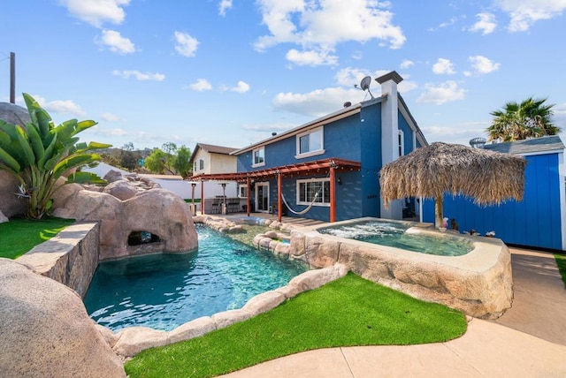 view of pool featuring an in ground hot tub, pool water feature, and a patio area