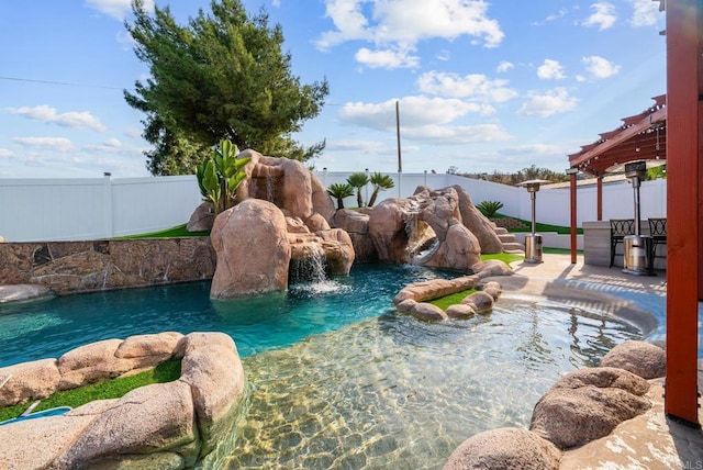 view of pool with pool water feature