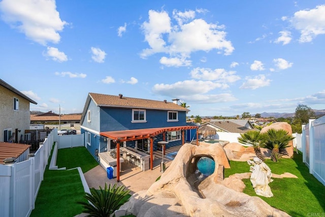 rear view of house featuring a patio area and a lawn