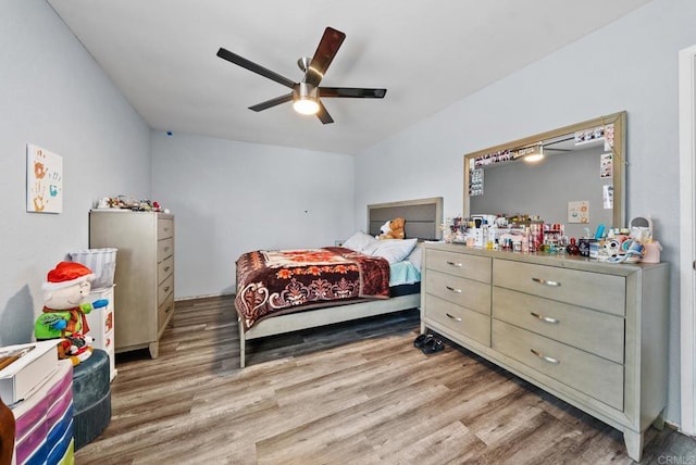 bedroom with light hardwood / wood-style flooring and ceiling fan