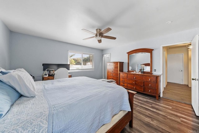 bedroom with dark hardwood / wood-style floors and ceiling fan