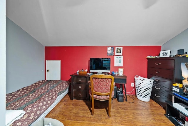 bedroom featuring lofted ceiling and light wood-type flooring