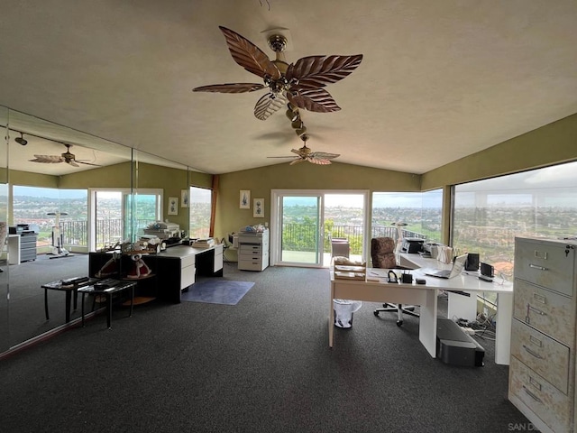 carpeted home office with ceiling fan and lofted ceiling