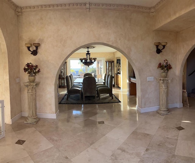 unfurnished dining area featuring a notable chandelier and a high ceiling