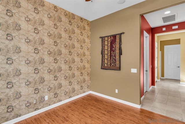 empty room with wood-type flooring and ceiling fan