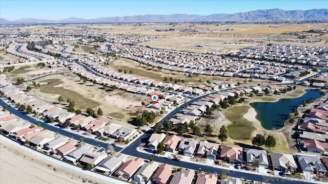 drone / aerial view featuring a water and mountain view