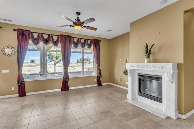 unfurnished living room with light tile patterned floors and ceiling fan