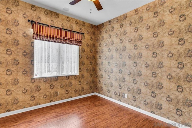 unfurnished room featuring hardwood / wood-style flooring and ceiling fan