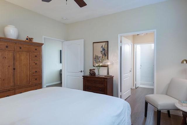 bedroom with ceiling fan and dark hardwood / wood-style floors