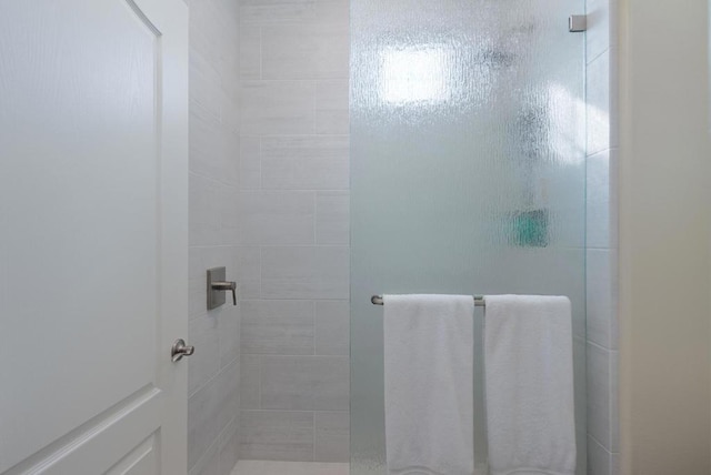 bathroom featuring a shower with door