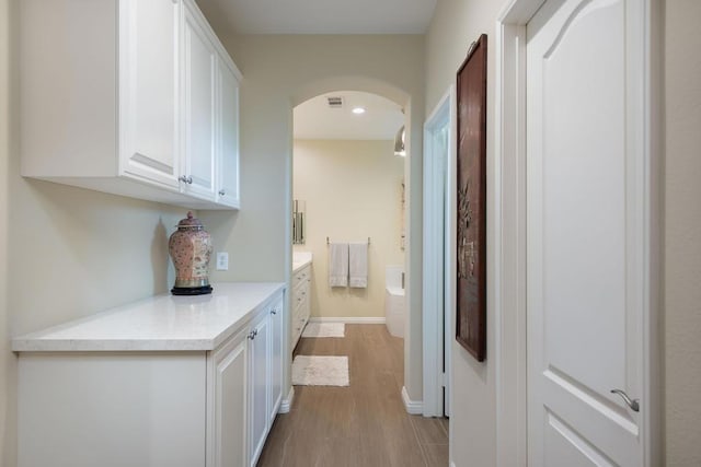 hallway with light hardwood / wood-style flooring