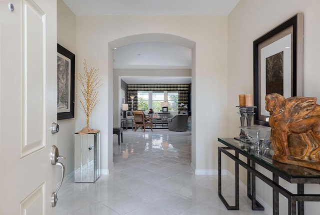 hall featuring light tile patterned floors