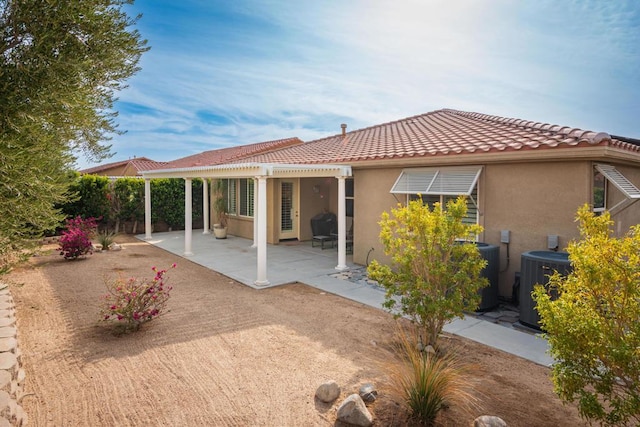 back of property with a patio area and central air condition unit